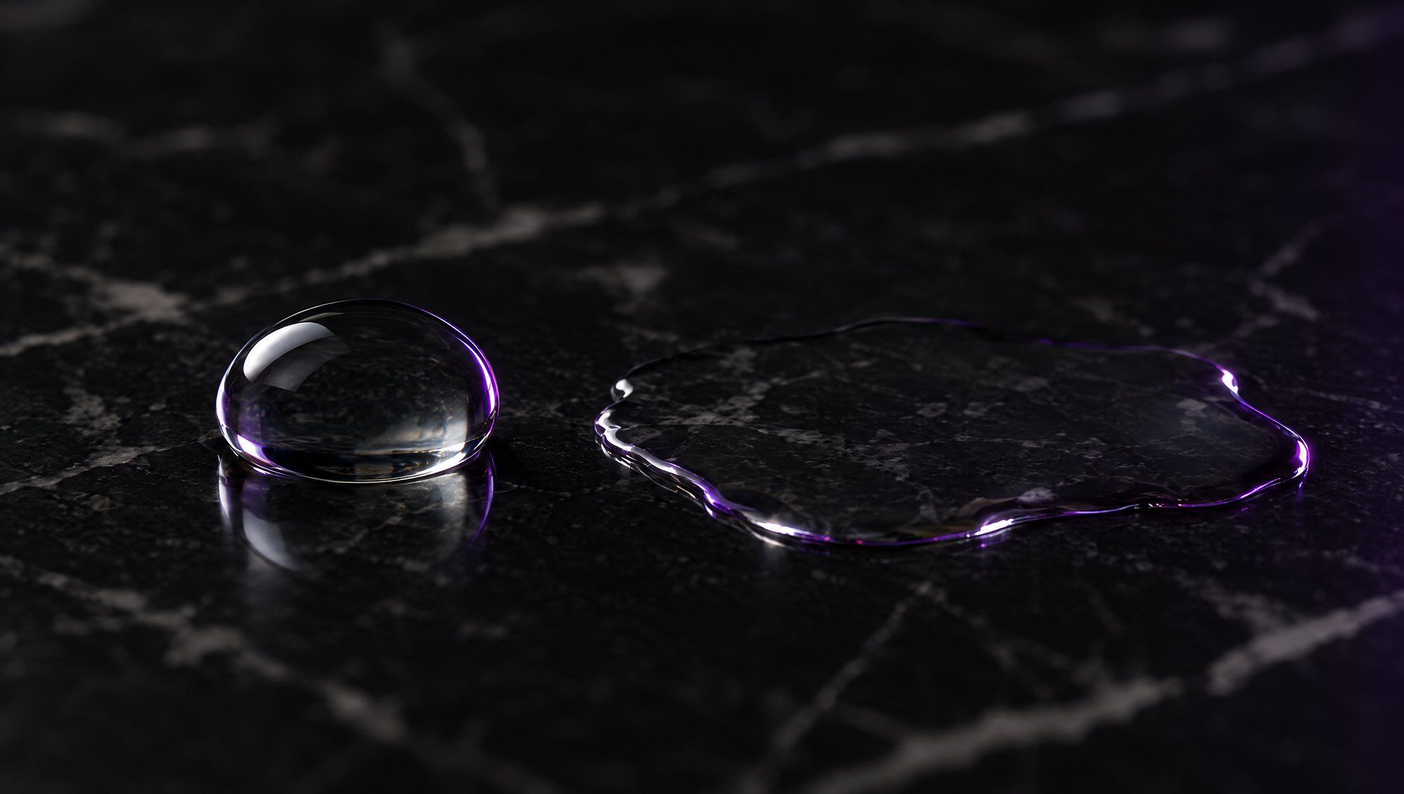 Two drops of clear liquid side by side on dark marble, one round and one spreading thin, their edges lit in plum light.